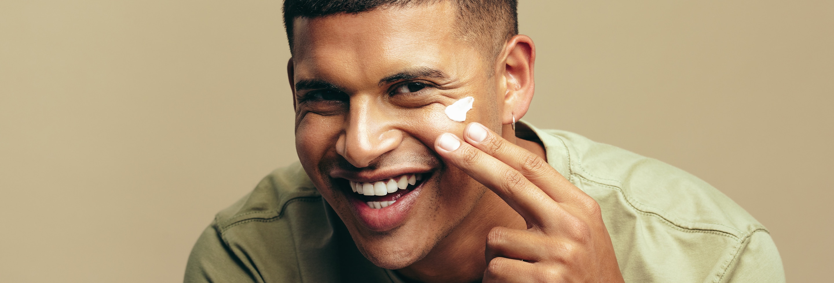 Man face slugging by applying moisturizing 