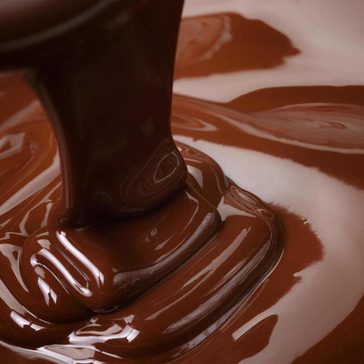 Glossy melted chocolate poured into a mold