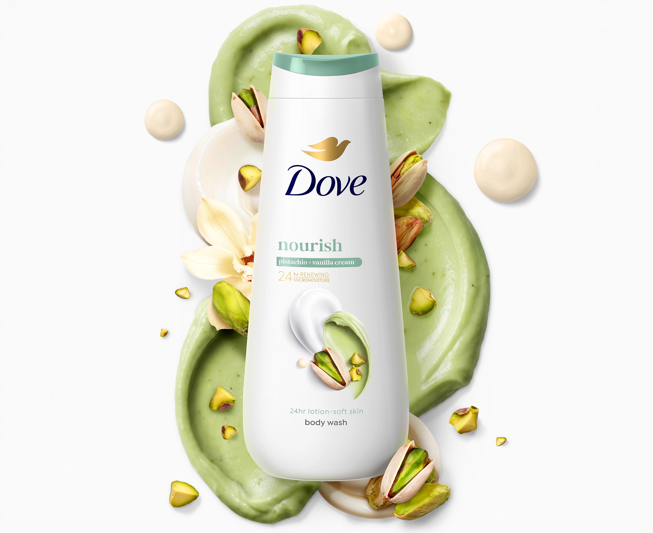 Dove Nourish Pistachio and Vanilla Cream Body Wash pack laying against green and white creamy textures with pistachio nuts laying around it