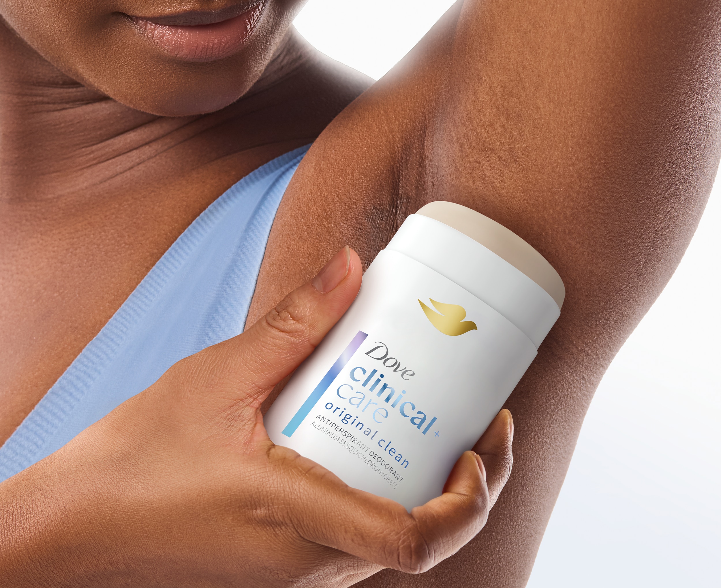Woman applying Clinical Care Original Clean Antiperspirant Deodorant to underarm