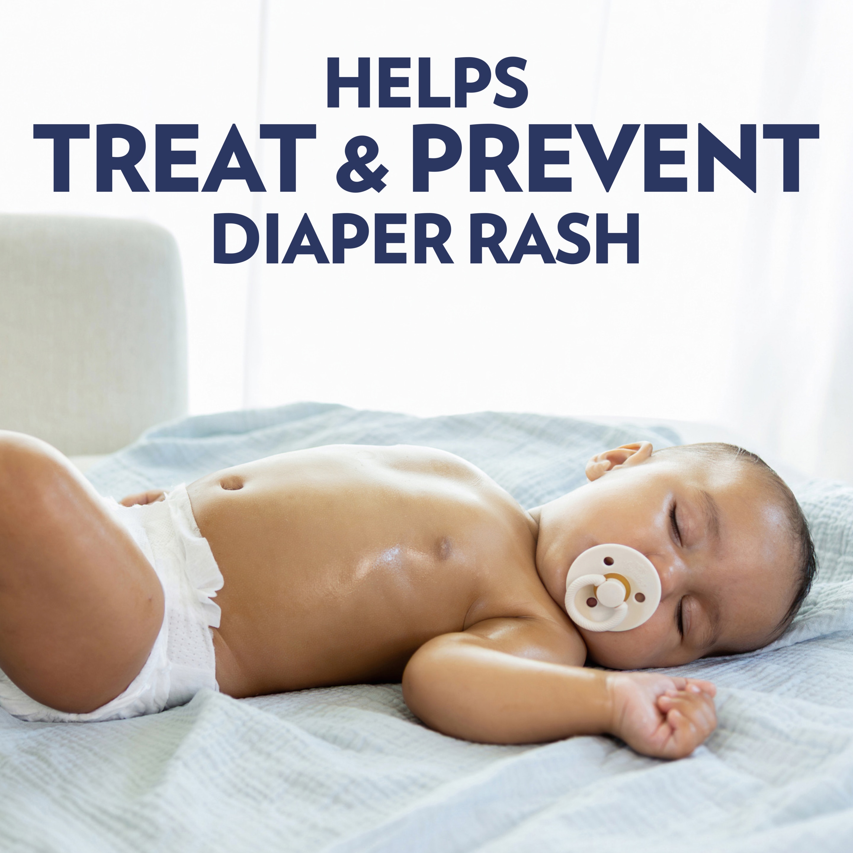 A baby wearing a diaper and pacifier lies on a light blue blanket, with text