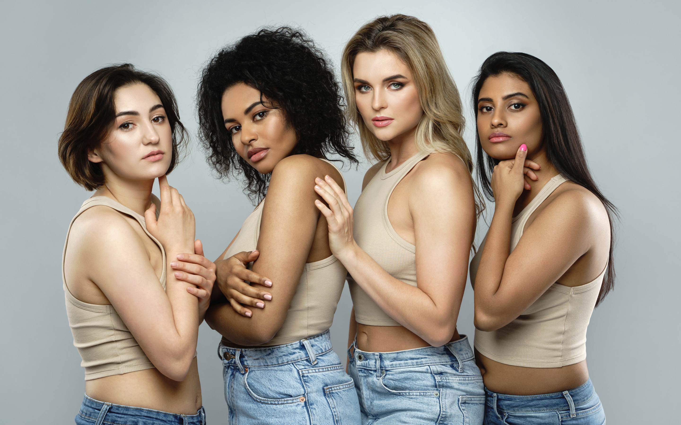 Group of women with different face shapes all looking to camera in a studio set.