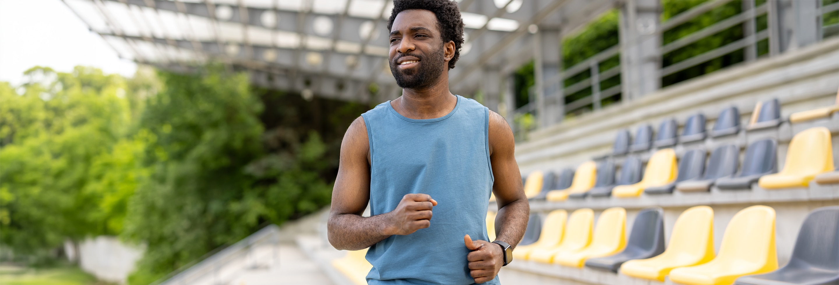 Man outdoors in a stadium, wearing athletic clothing and not worrying about rough,&nbsp;bumpy&nbsp;and uneven skin&nbsp;