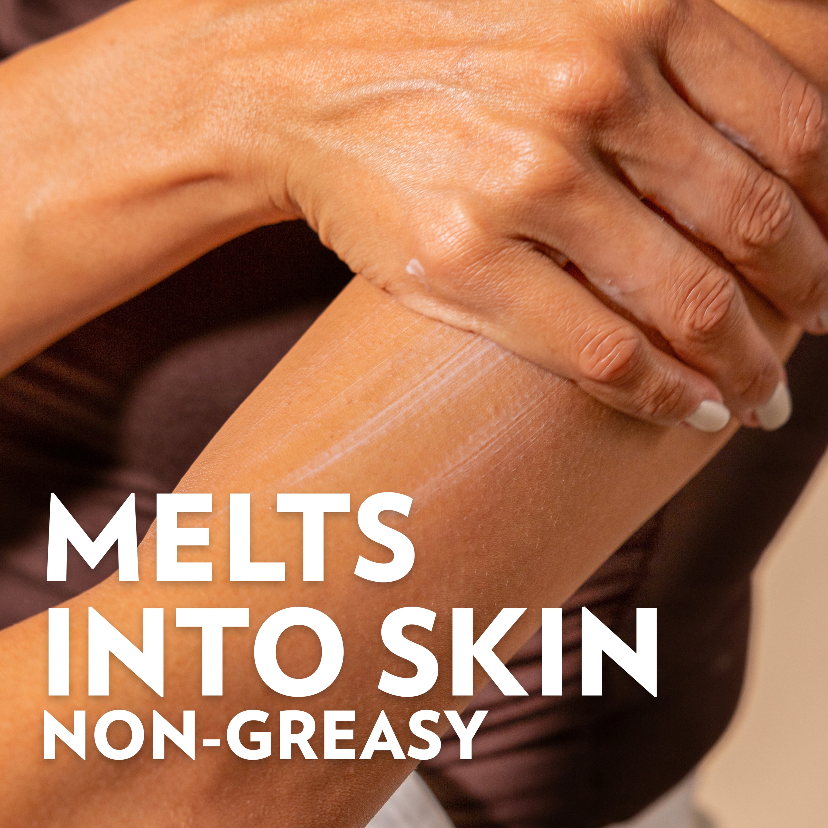 Close-up of lotion being rubbed into skin on an arm, with text