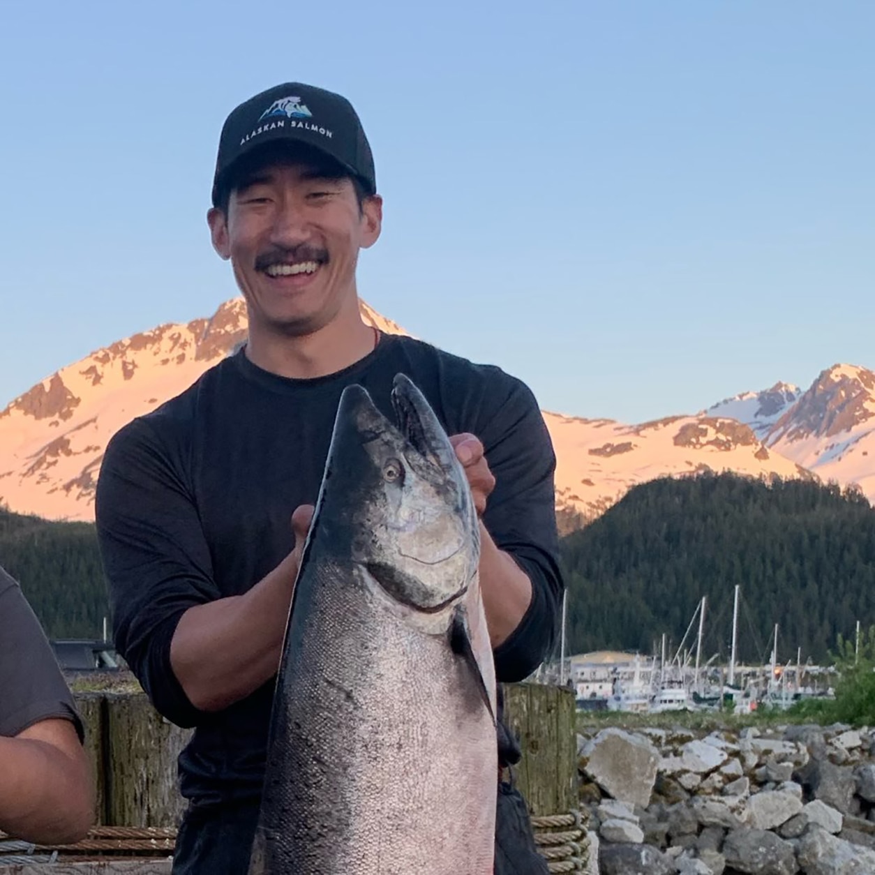 men holding a big salmon