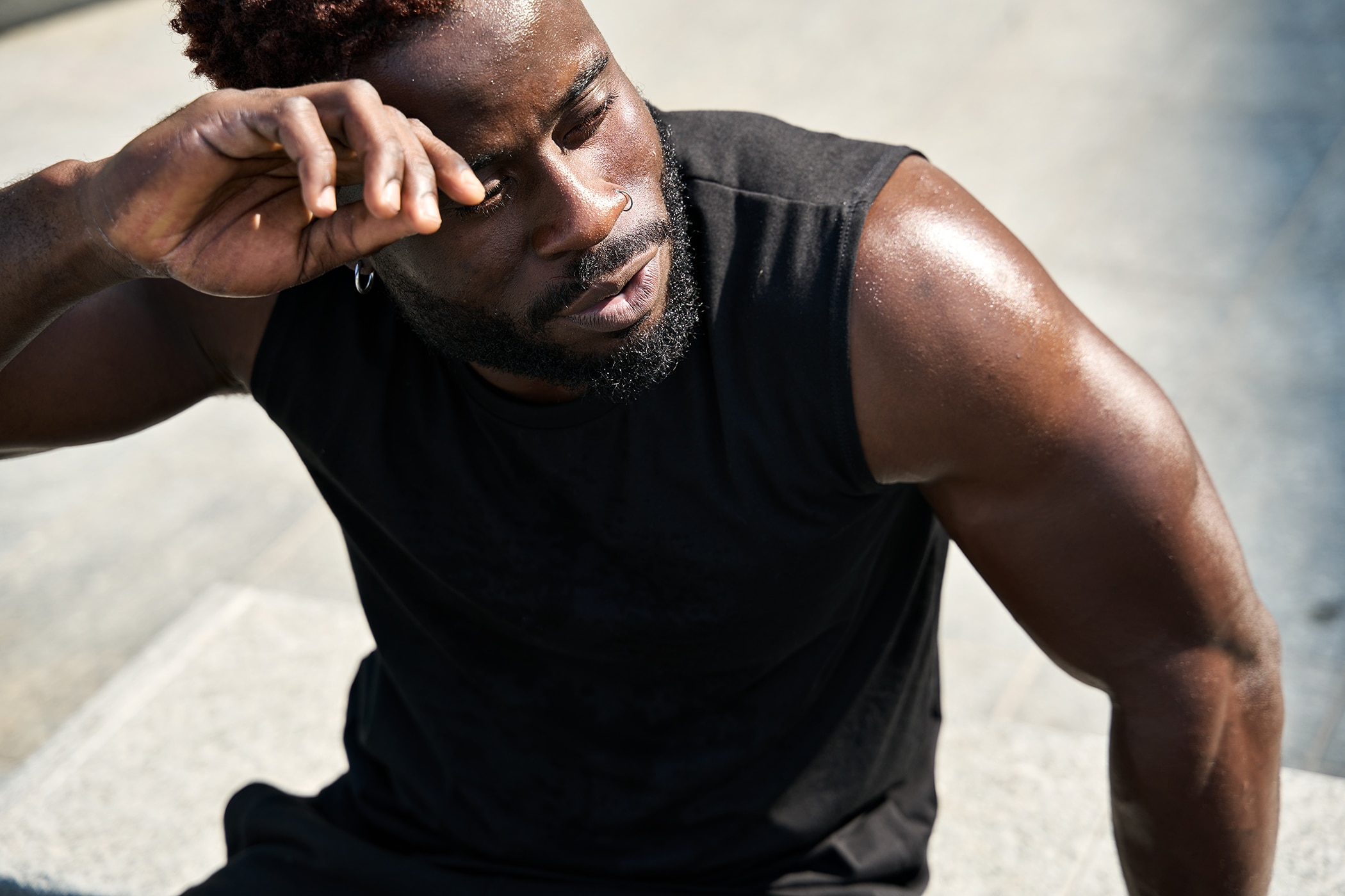 Young guy experiencing stress sweat and discomfort at summer’s end