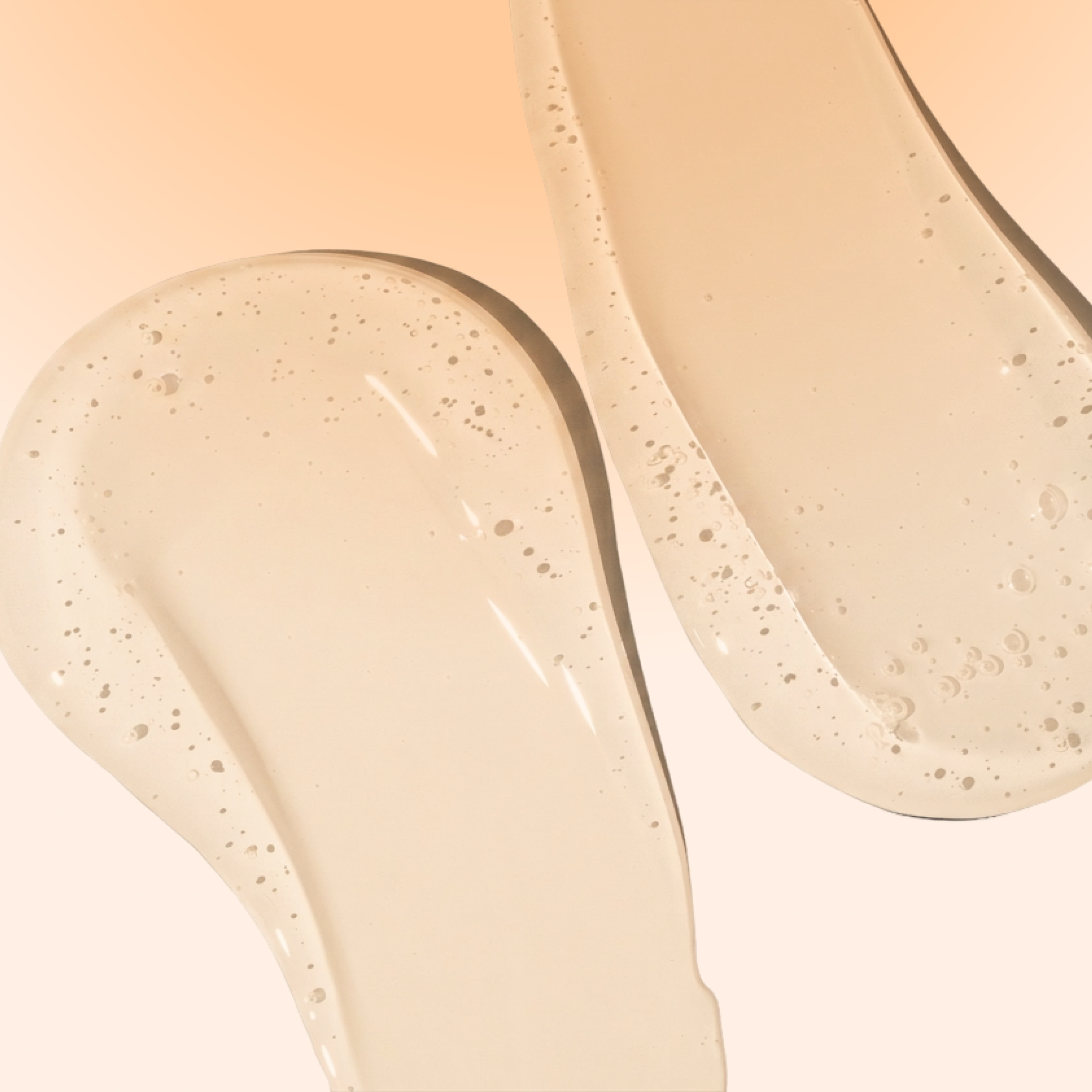 Close-up of two glossy gel oil swatches on a soft beige background