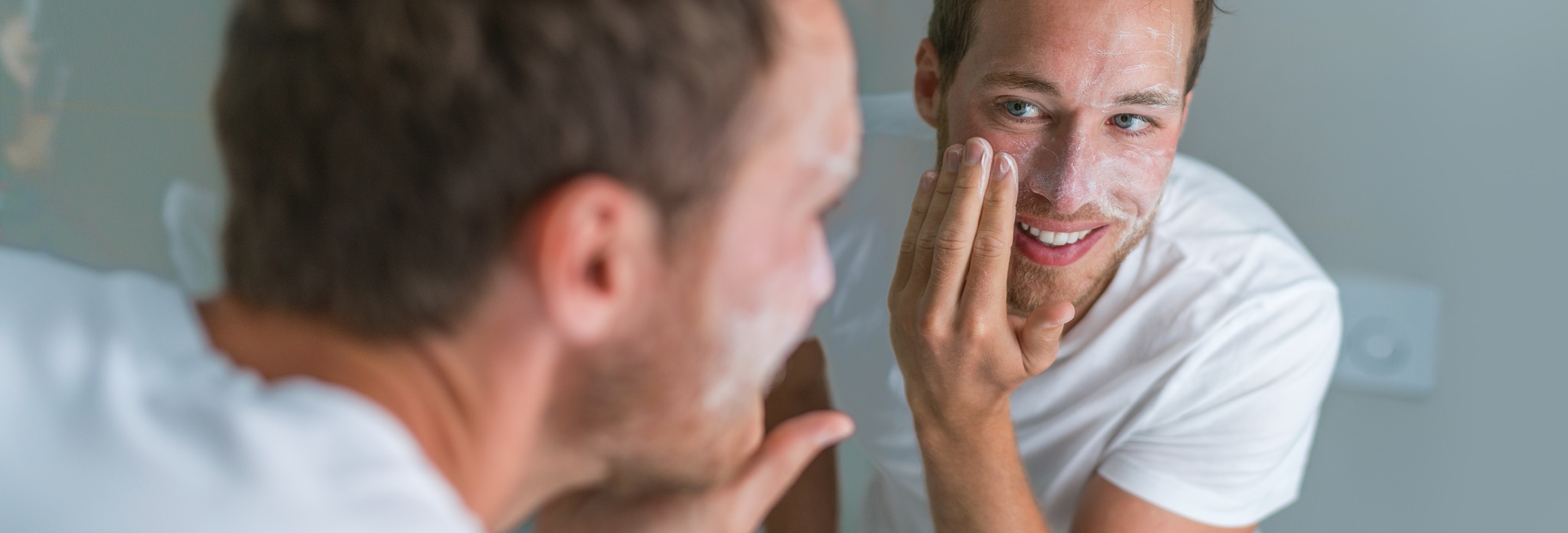Man washing his face with the best bar soap for pimples