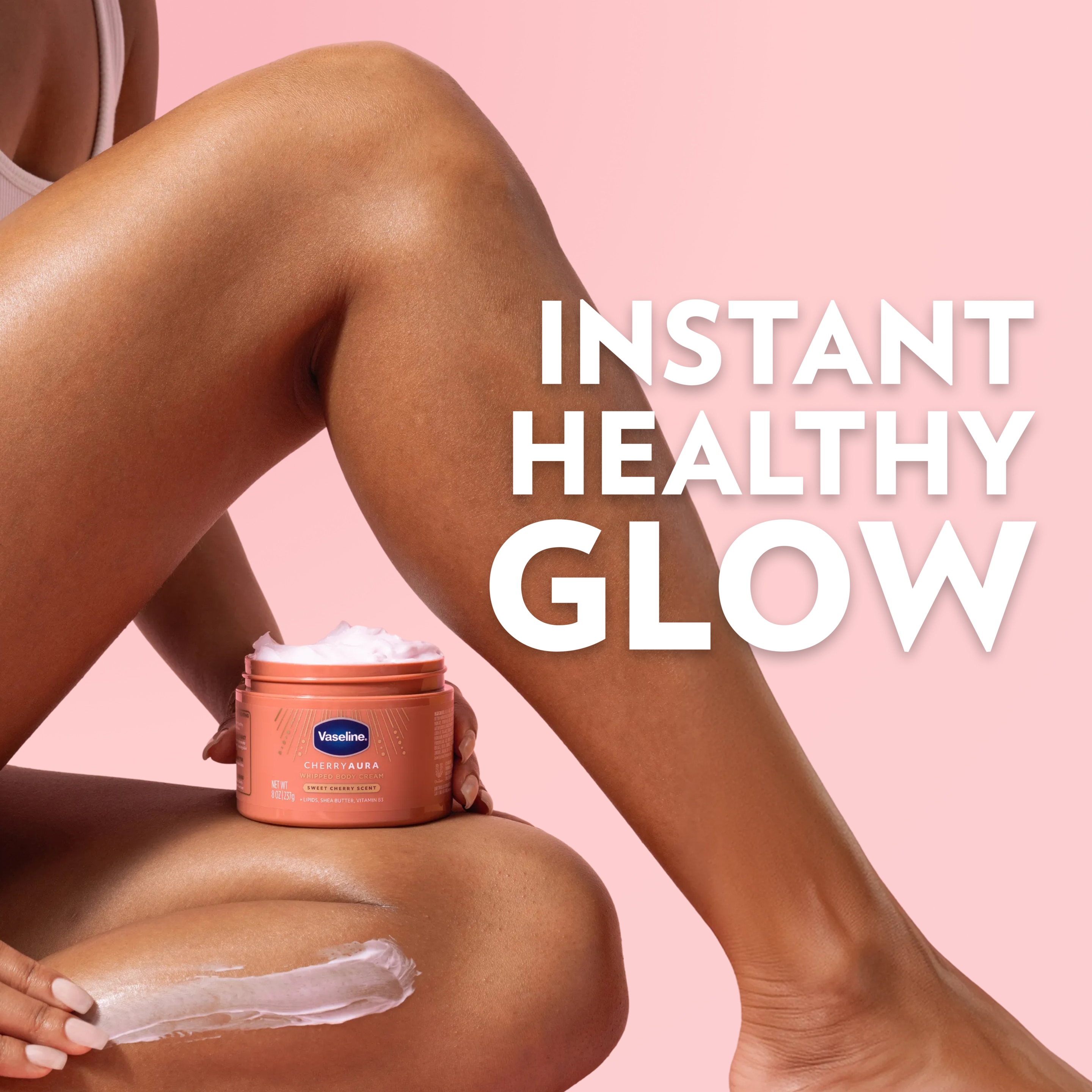 A jar of Vaseline Cherry Aura Whipped Body Cream is shown beside a cream application on the leg, with text