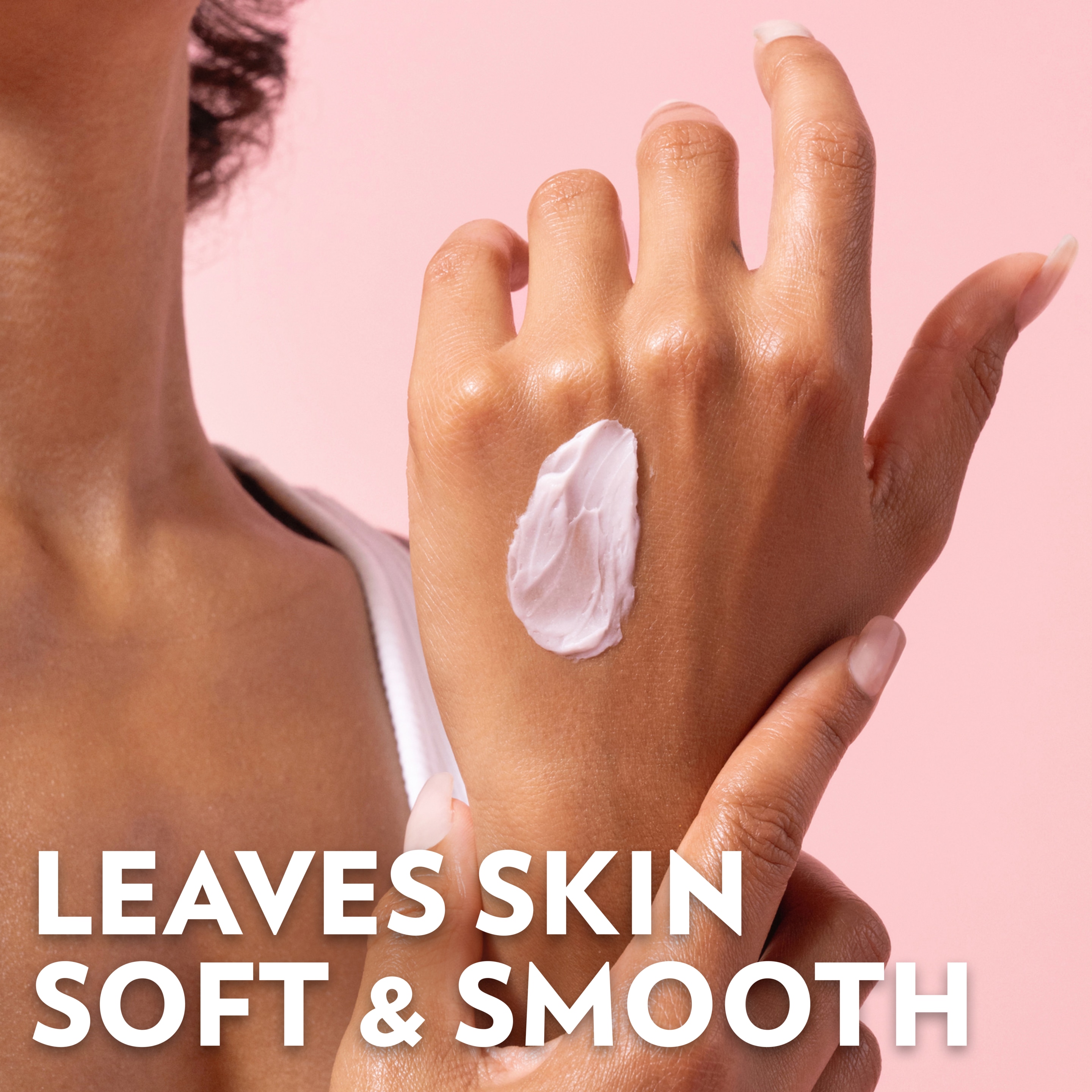 A close-up of hands applying a dollop of Vaseline Cherry Aura Hand Butter, with text