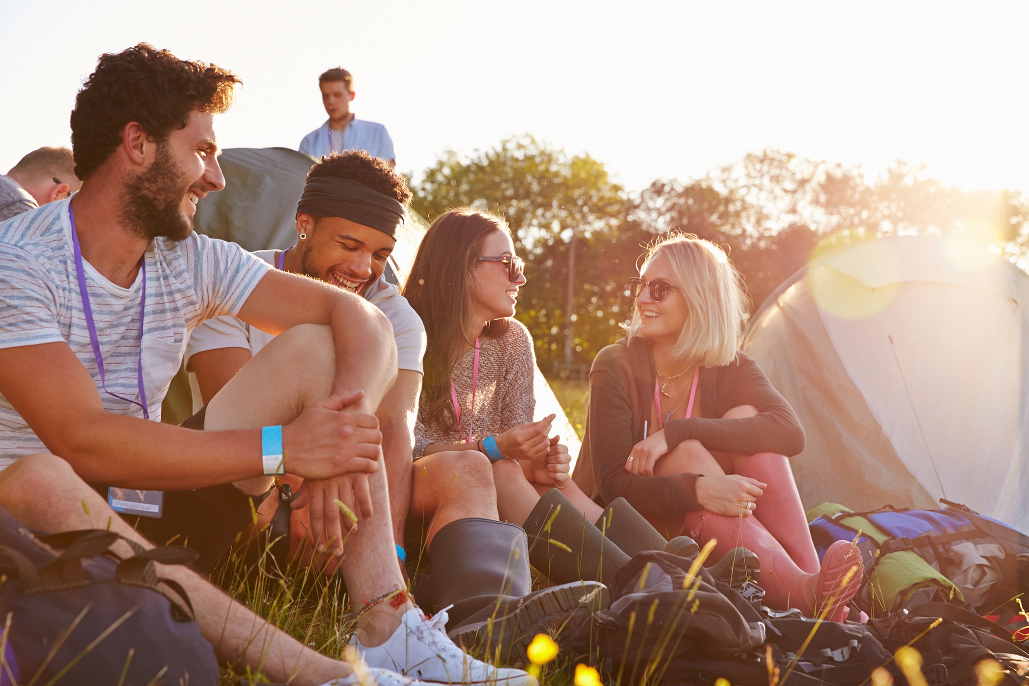 Group of friends camping in the summer who know all about camping hygiene