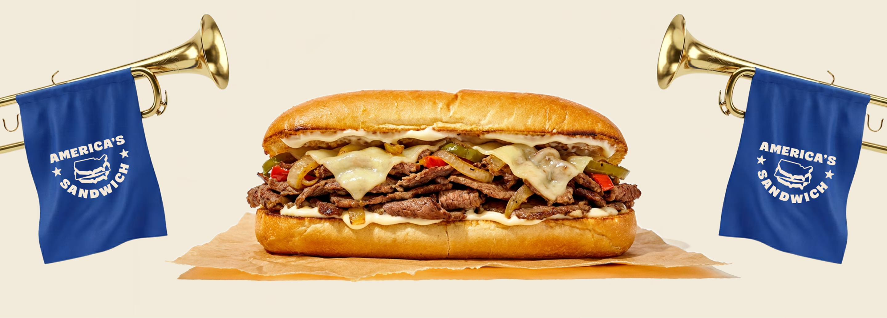 Cheesesteak sandwich topped with melted cheese, peppers, and onions, displayed between two blue 'America's Sandwich' flags.