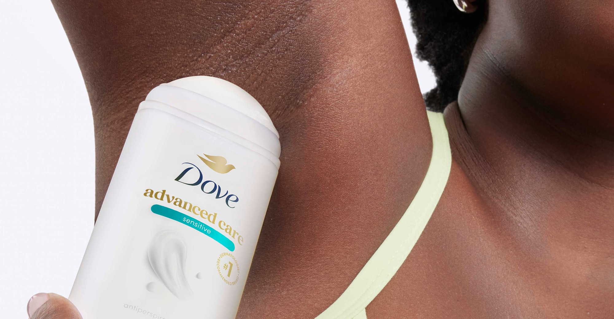 Woman applying Advanced Care deodorant stick to underarm
