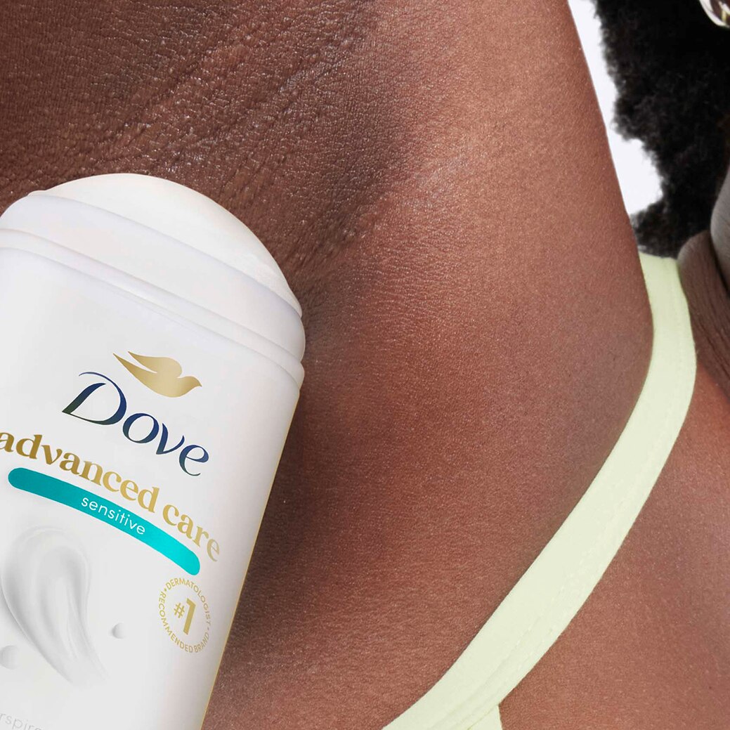 Woman applying Advanced Care deodorant stick to underarm