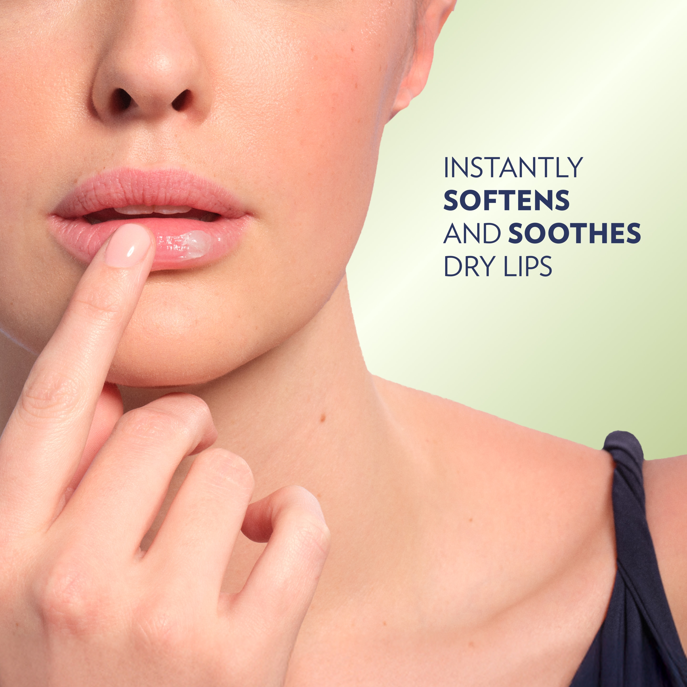 Close-up of lips with a finger applying Vaseline Lip Therapy Jelly to the lower lip against a light green background, alongside text