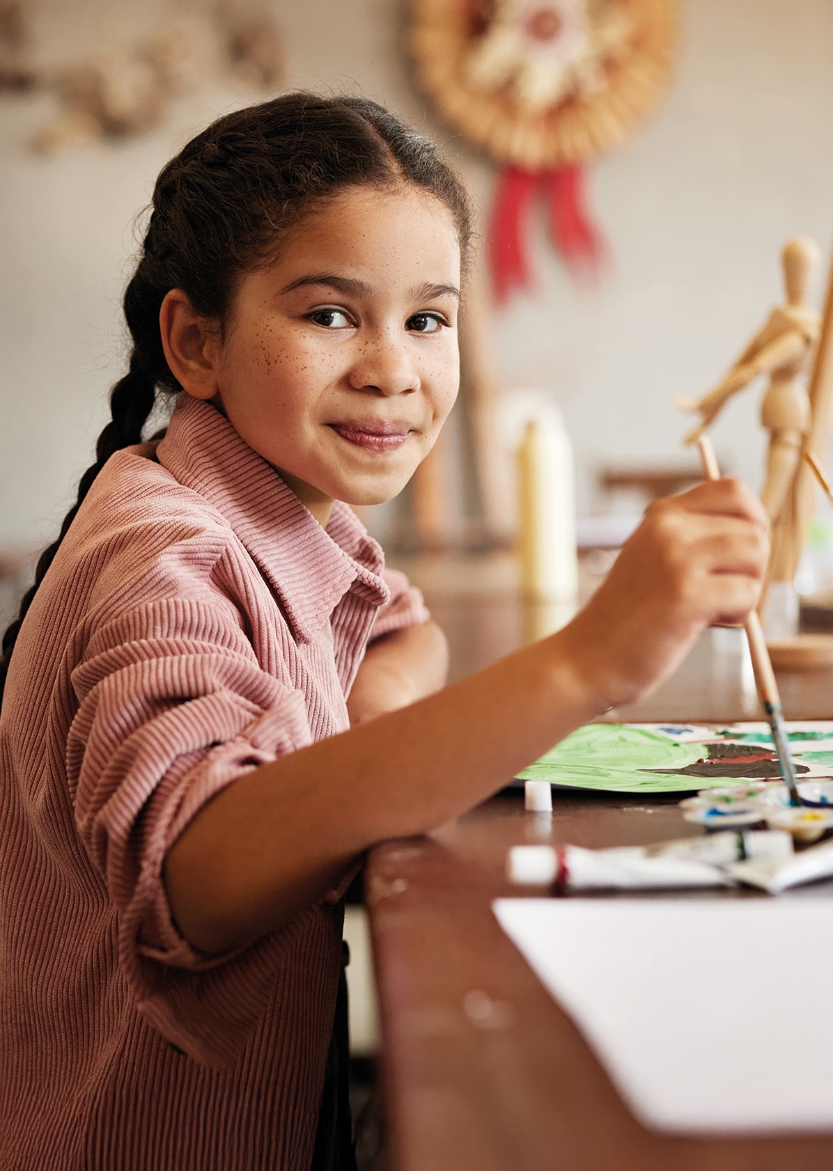 Girl smiling whilst painting 