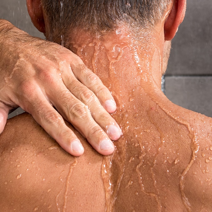 Man skin purging in the shower