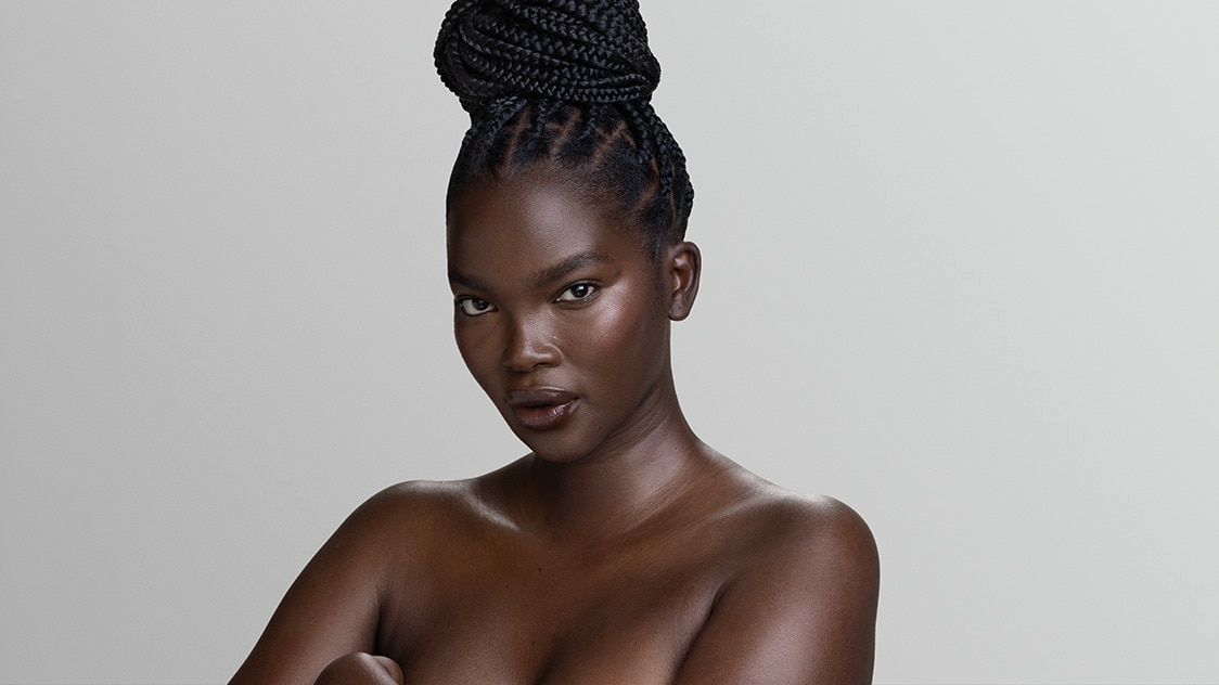 Beautiful woman with melanin rich skin looks at the camera