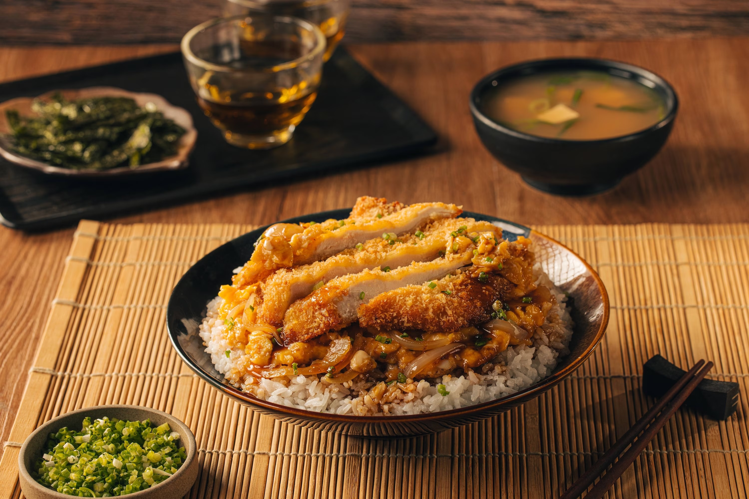 Chicken katsudon with sauce served over white rice.