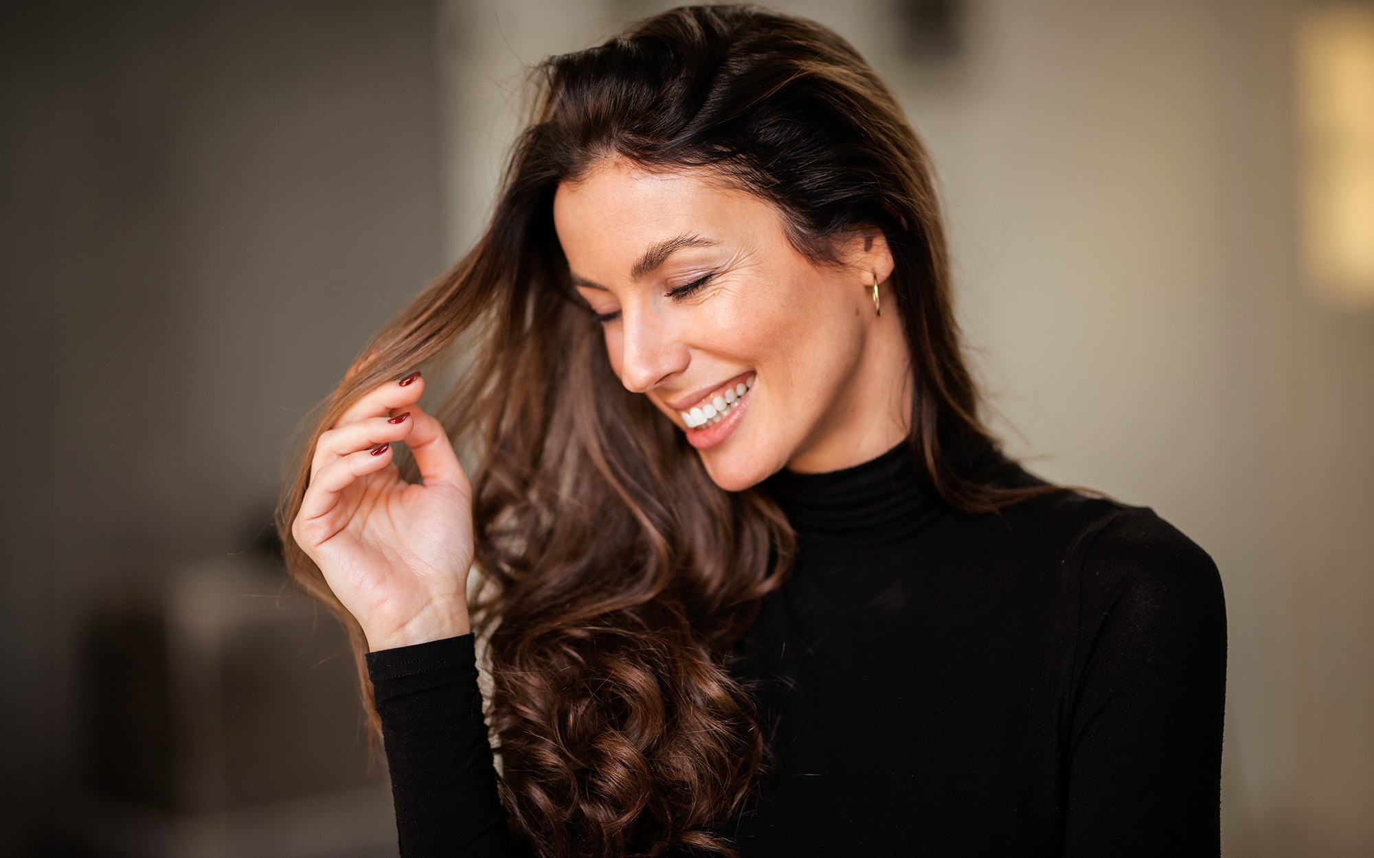 Woman enjoying blow-drying her hair