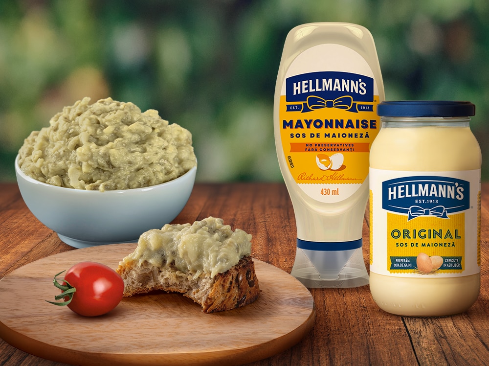 Someone sqeezzing mayonnaise on a sandwich