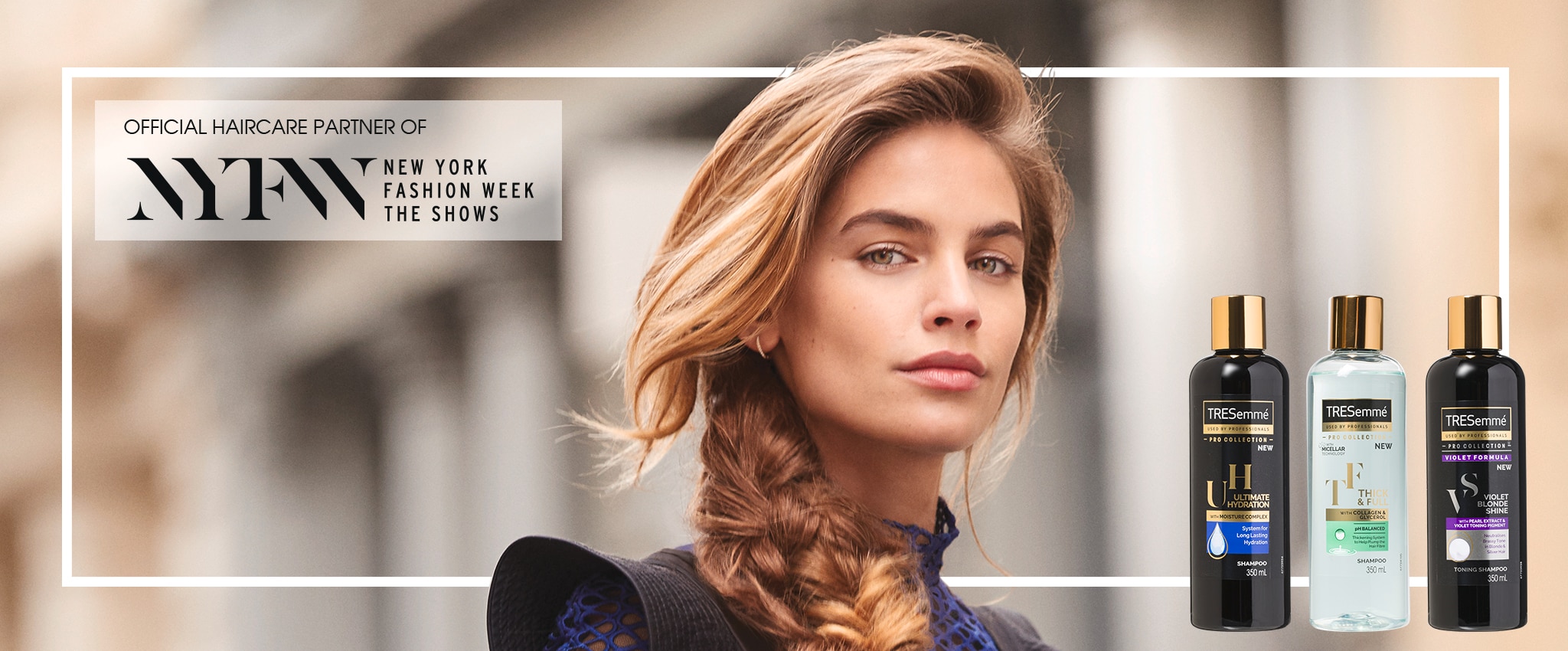 Two stylists use a brush and a hair dryer to style a woman's hair.