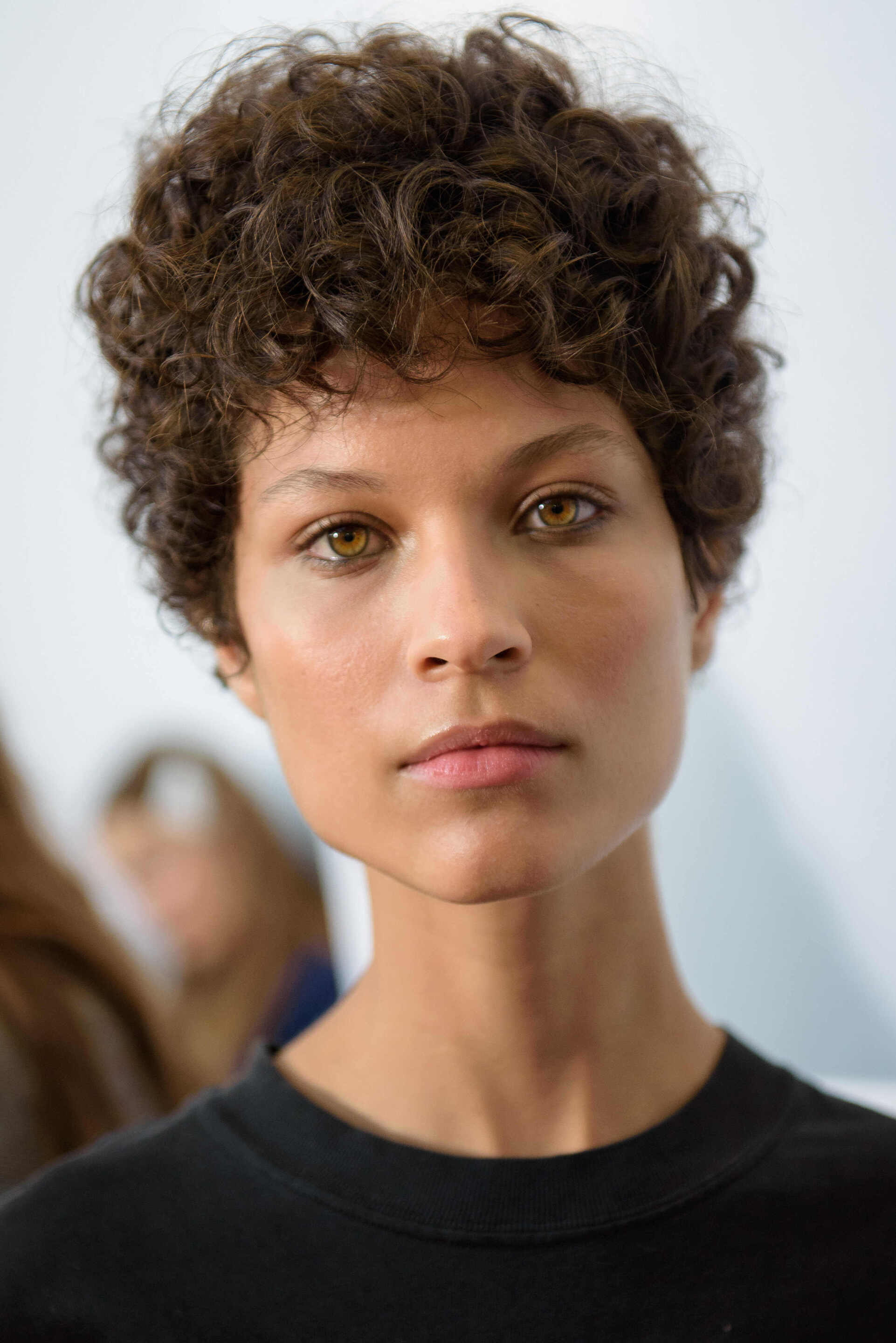 short hairstyles for heart shaped faces: close up shot of brigette lundy paine with a chin length bob hairstyle, wearing floral tank top and orange choker on the red carpet