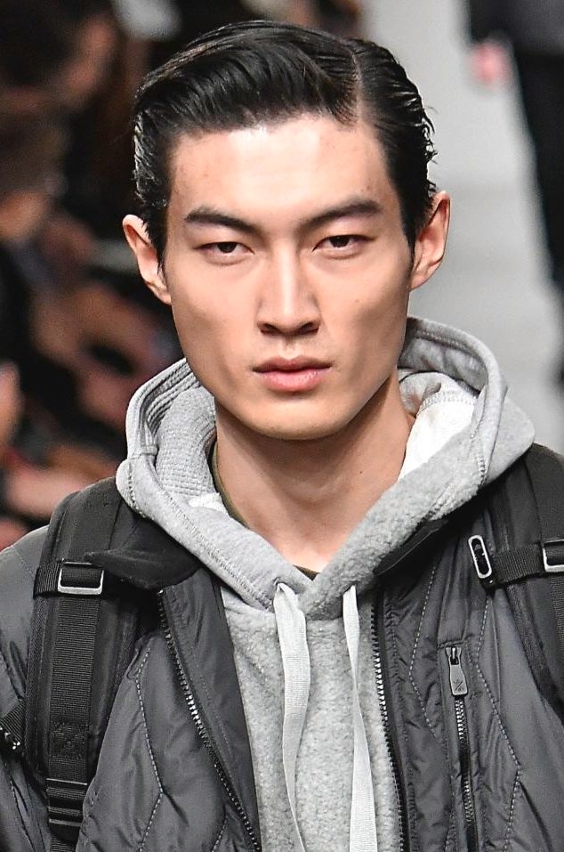 curtains hairstyle: shot of male model with blonde curtains bangs at london collection men show