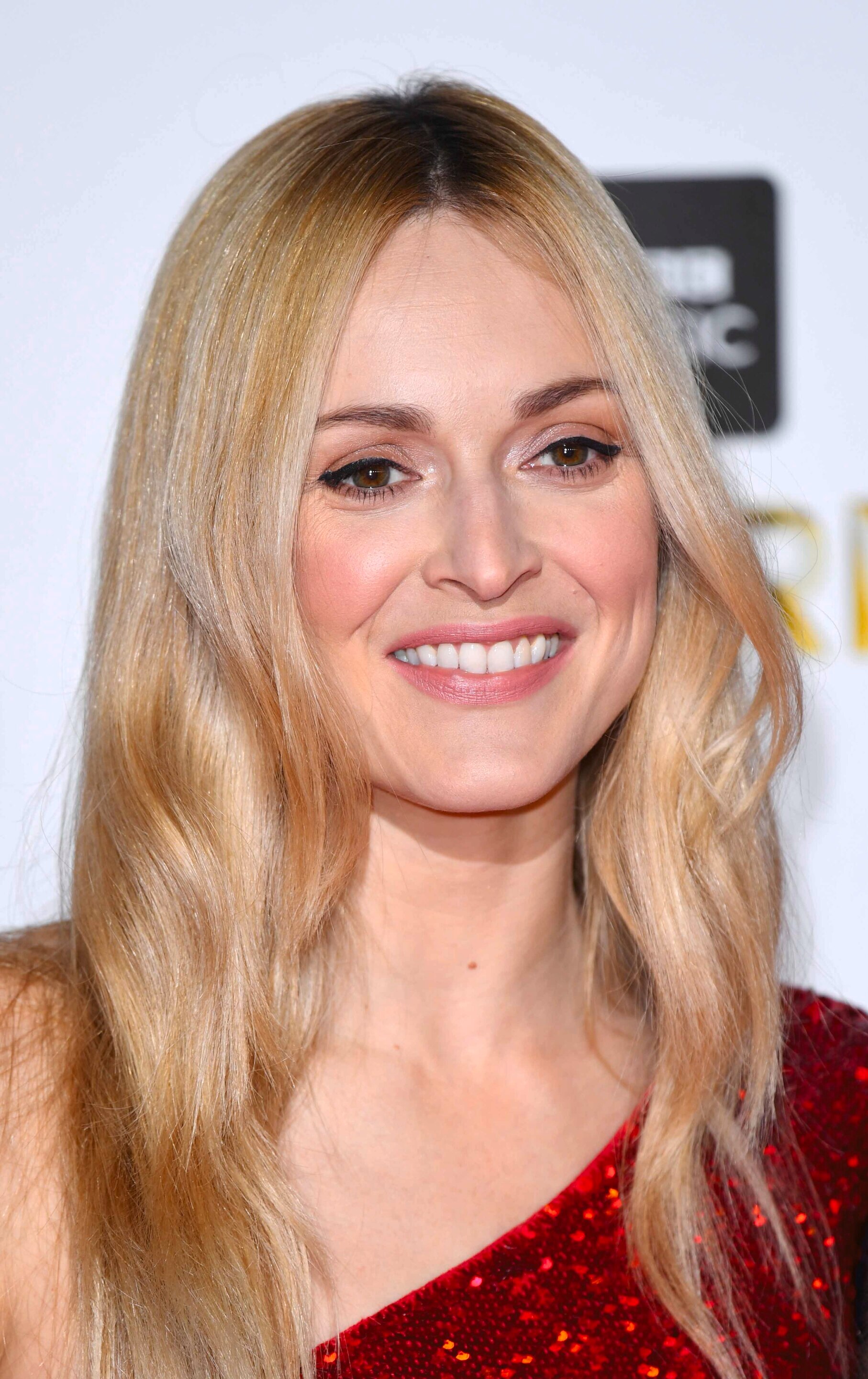 Woman with long wavy golden honey blonde hair