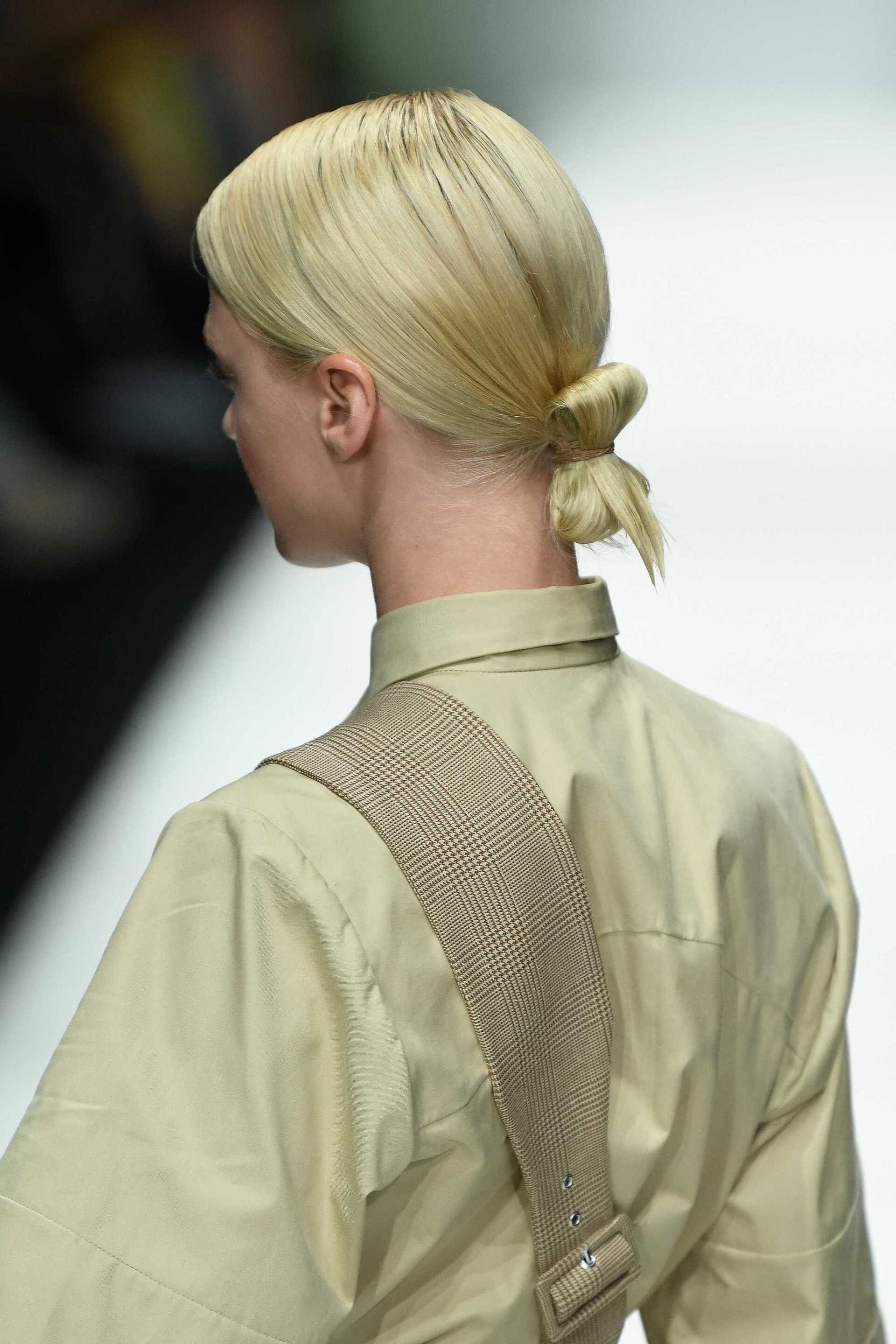 Gibson girl hair: Back view of a woman with dark brown hair in a Gibson roll hairstyle with diamante details