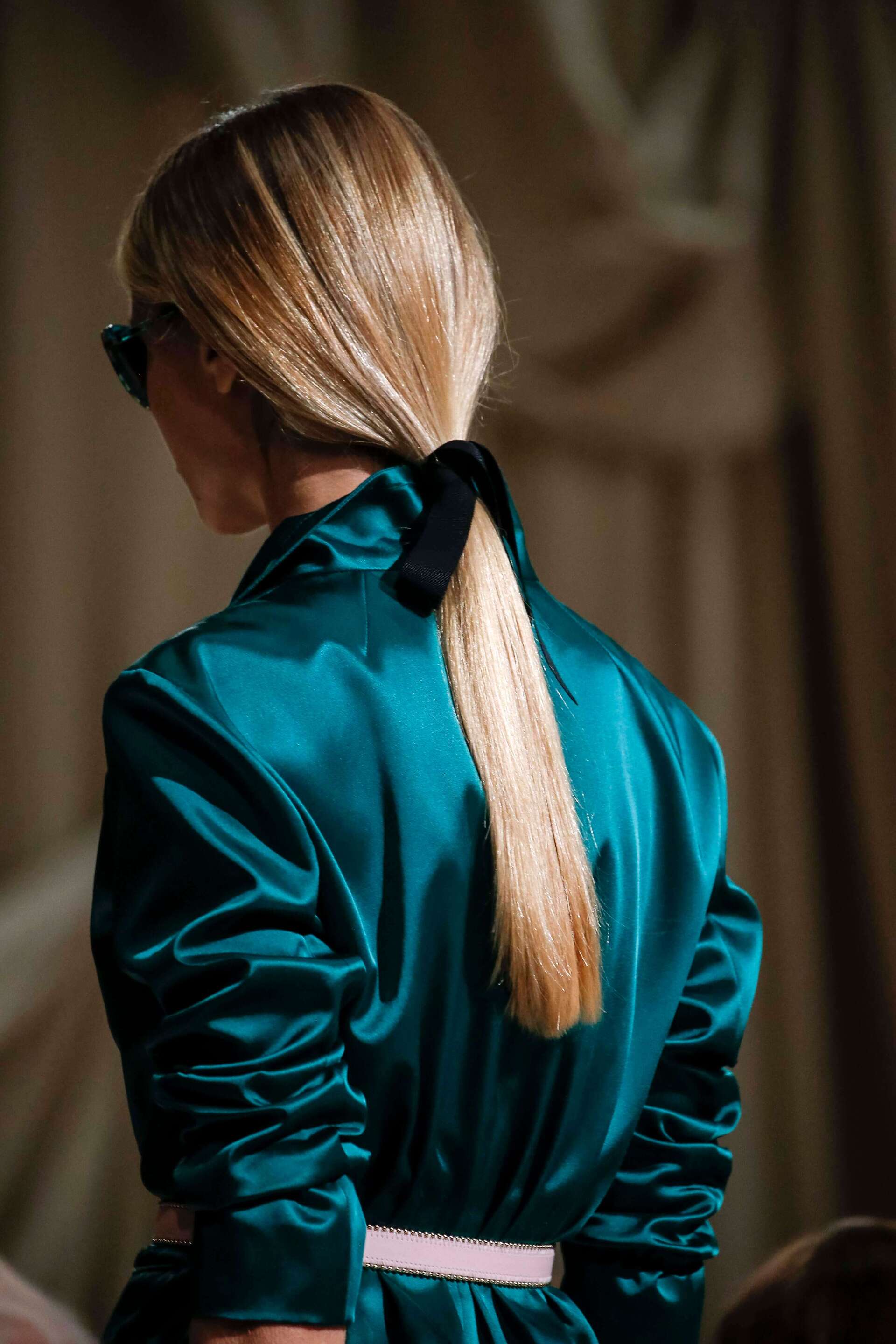 Asian woman with blonde curly long bob haircut