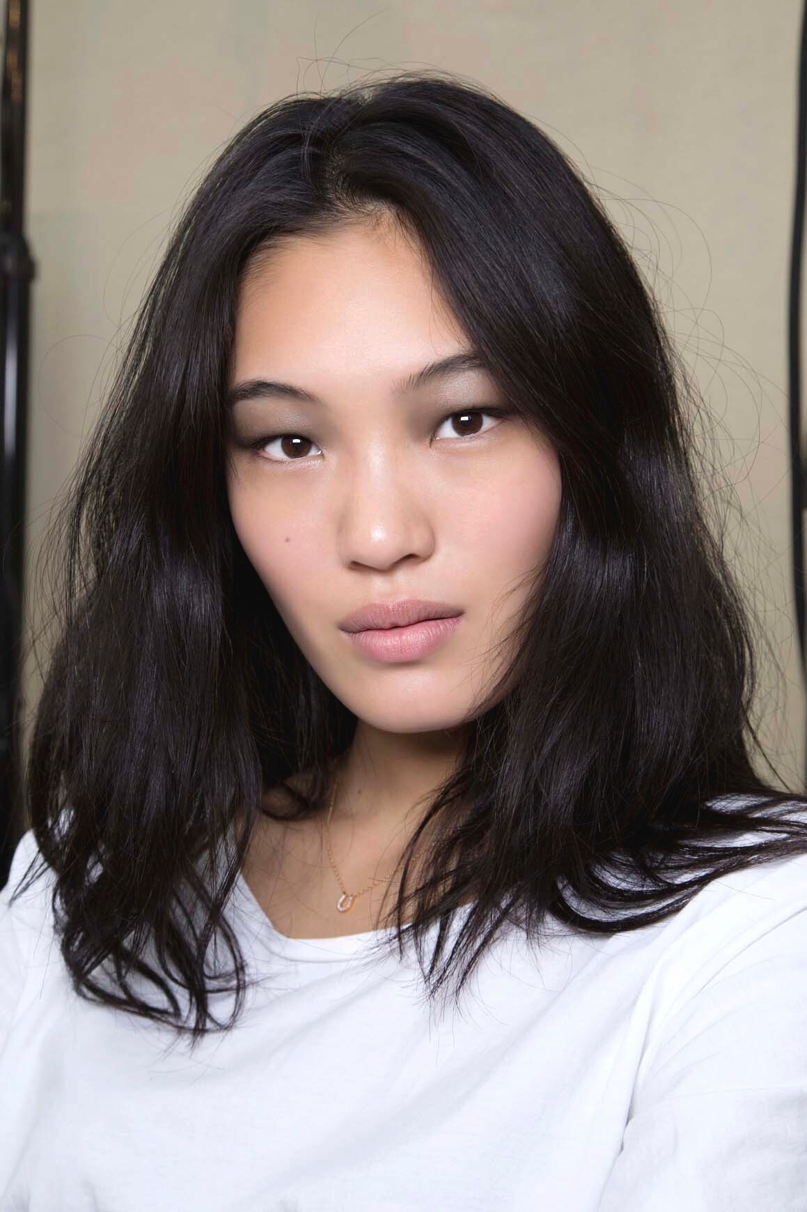 Asian hairstyles: Asian model with dark brown straight thick hair.