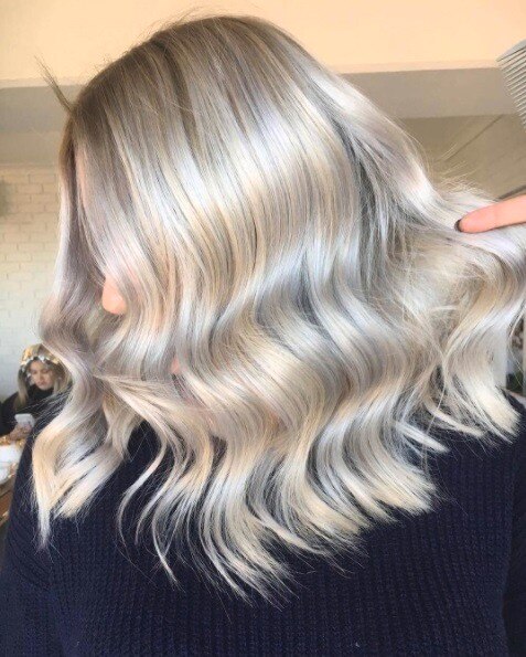 Woman with bleach blonde wavy long hair