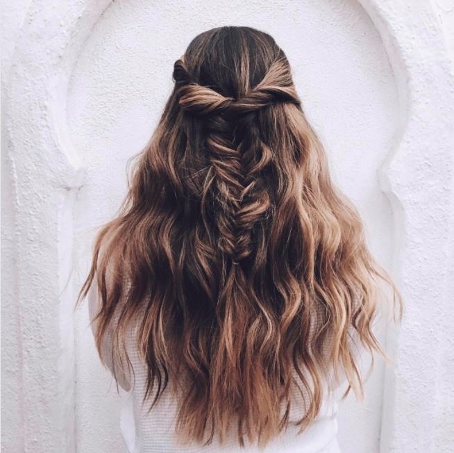 woman with long wavy dirty blonde long hair with multi-coloured single dreadlock