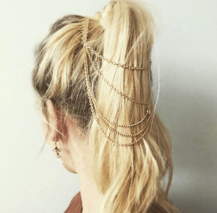 Hairstyles for turtleneck dress: Camila Coelho with medium chocolate brown hair styled into a half-up, half-down bun hairstyle, wearing turtleneck dress with jacket outside