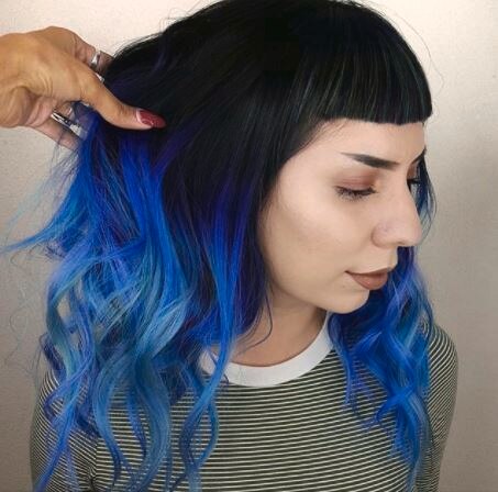 woman with dark brown hair with blue ombre finish