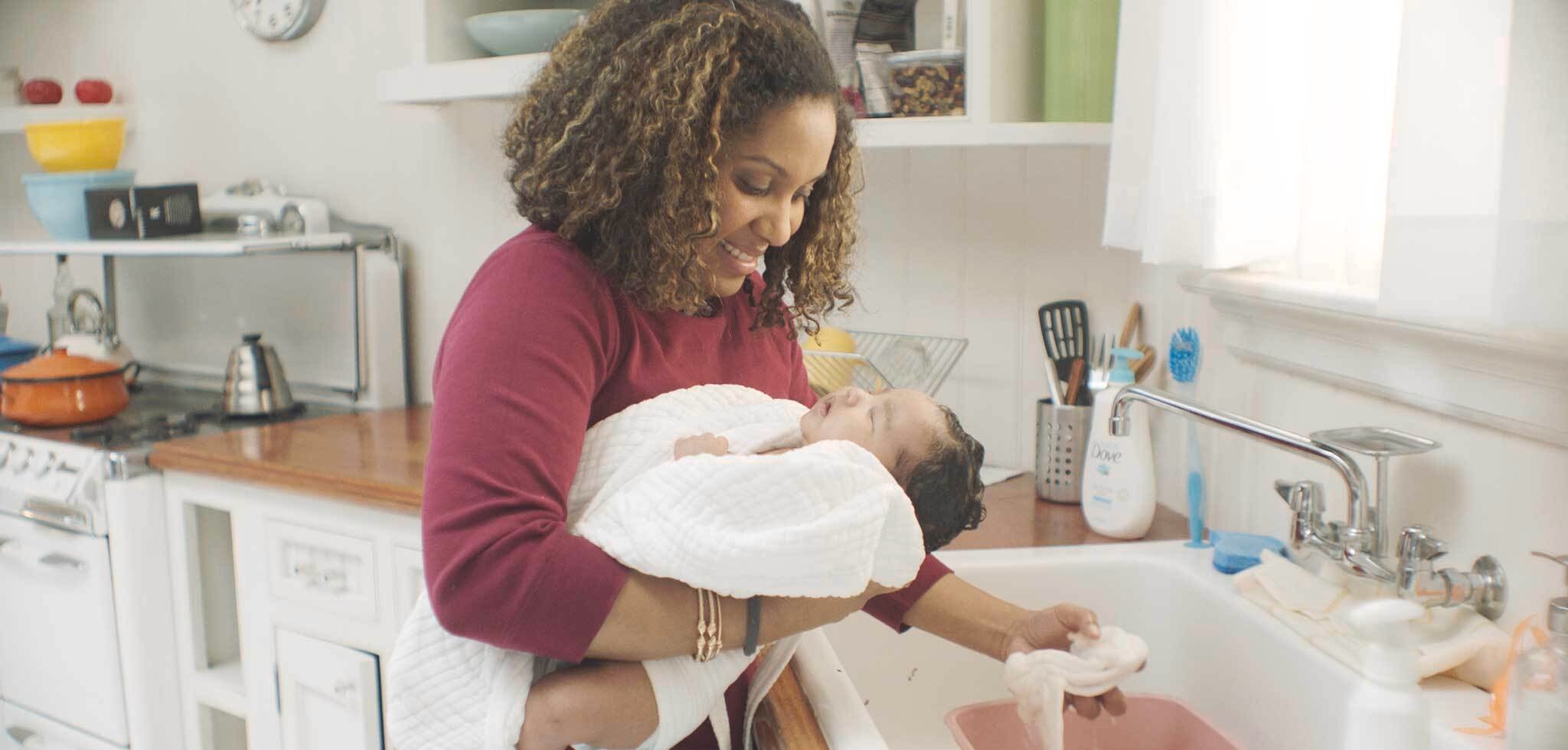 Mom and Doula giving baby a bath
