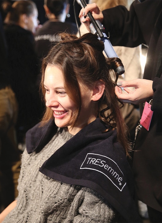 A model getting her hair done.
