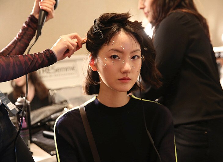 A model getting her hair done.