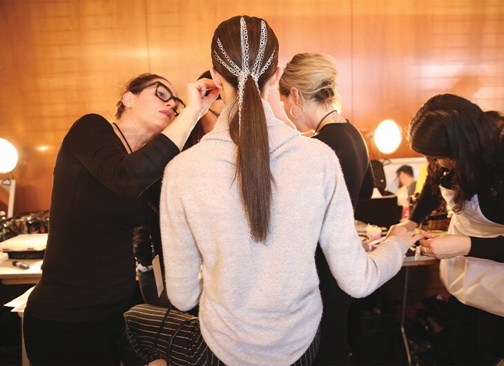 A stylist adding finishing touches.
