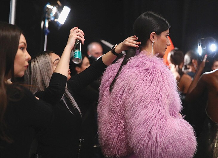 A stylist adding finishing touches.