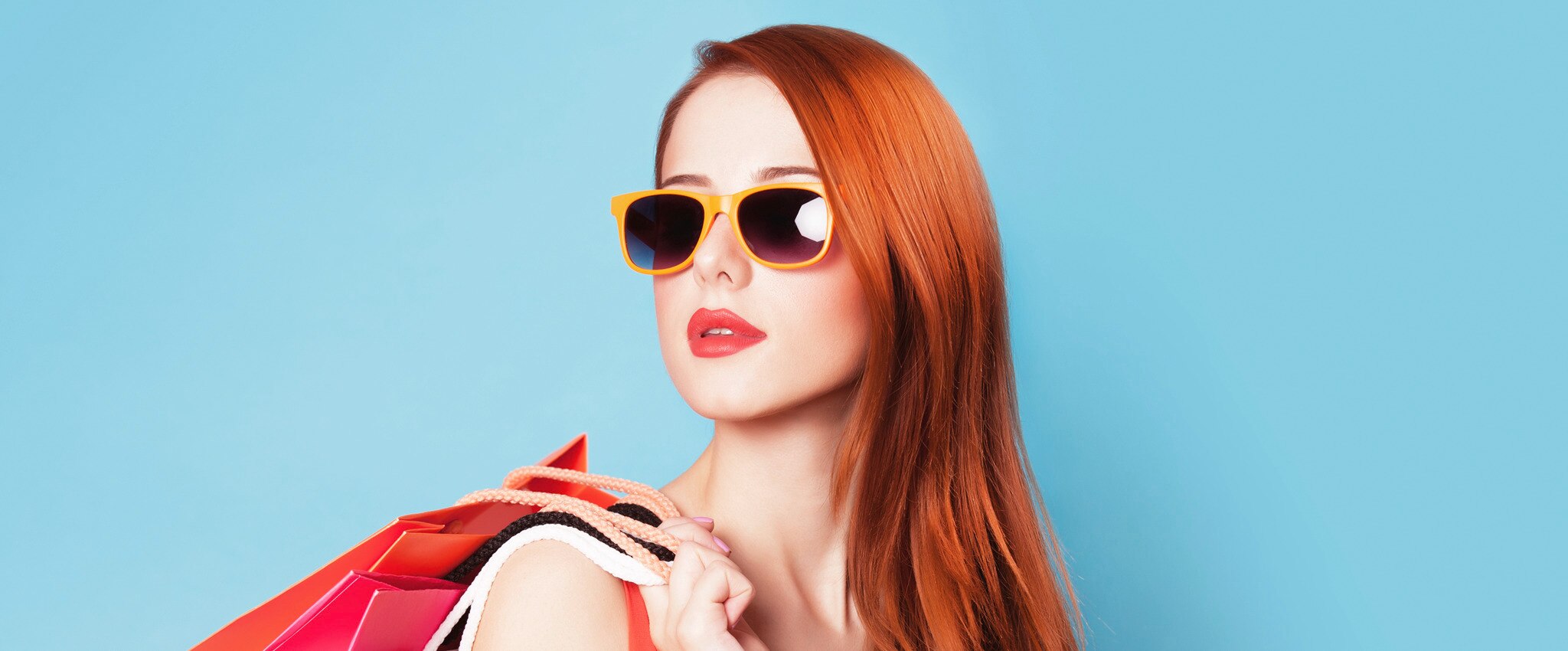 lady with shopping bags wearing glasses