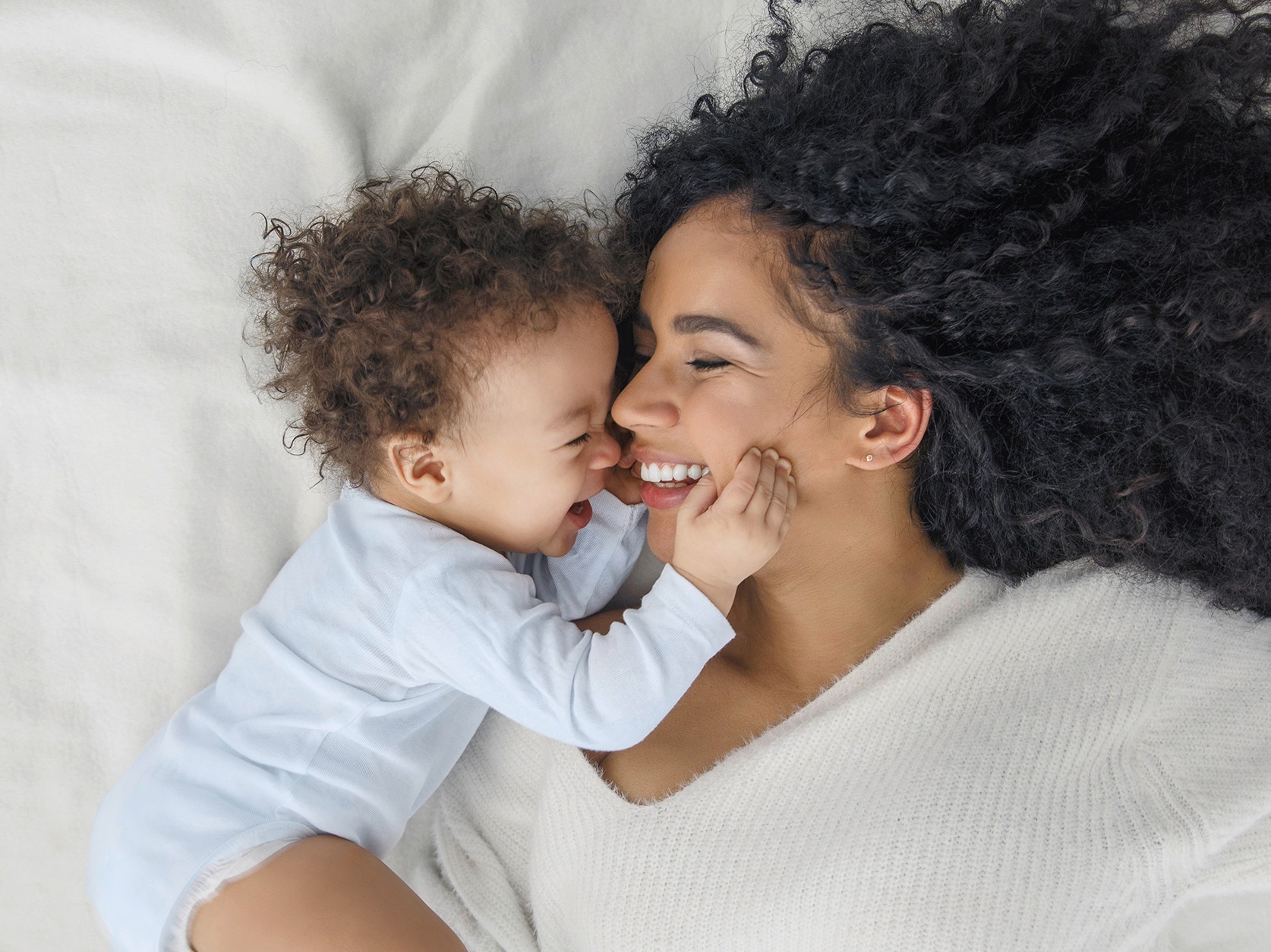 woman and baby smiling