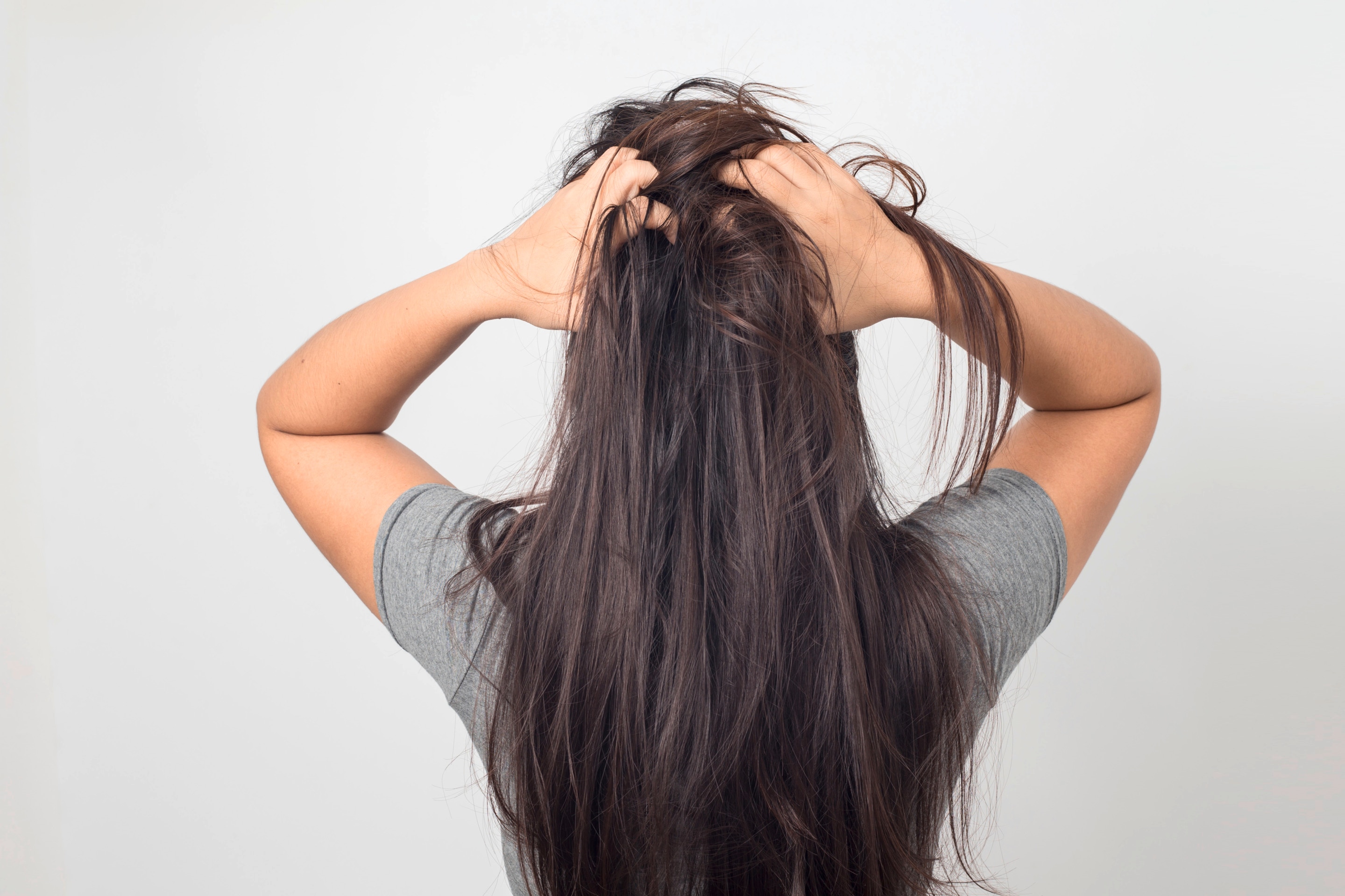 Women with itchy scalp scratching hair Text