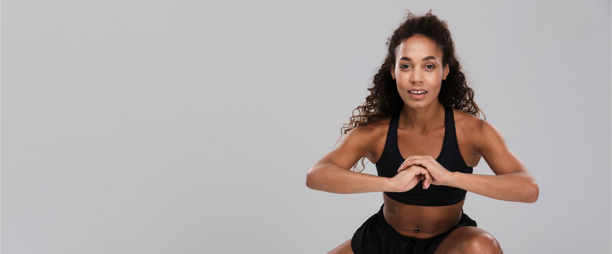 African American woman performing side leg lunges.