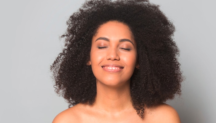 African American millennial woman isolated on grey studio background