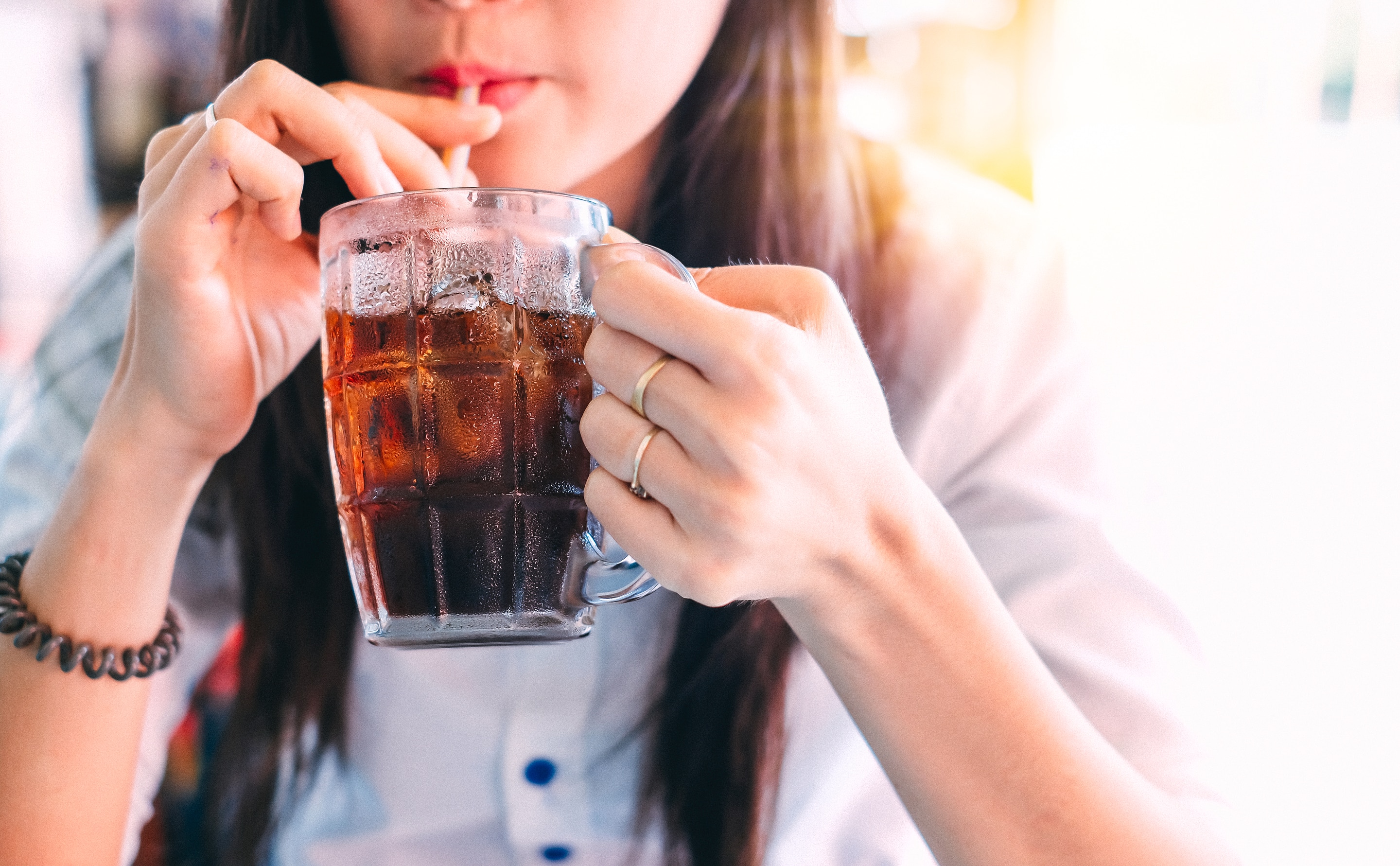 Asian woman drinking soda