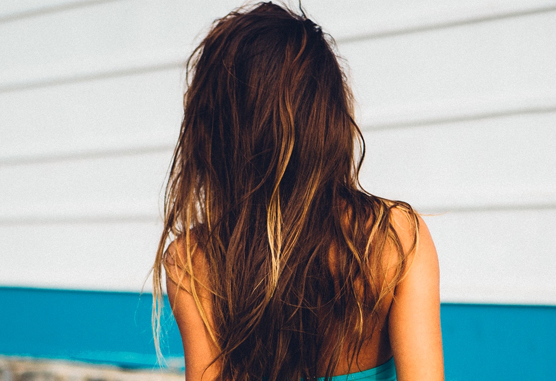 Brunette woman with beach waves and lightened hair