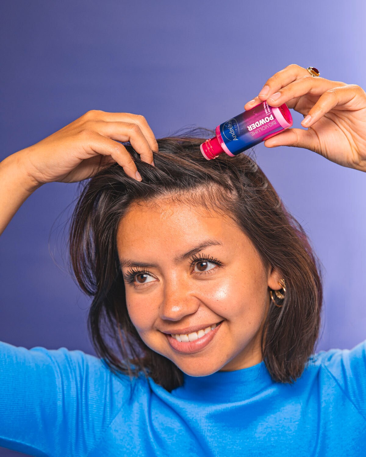 Girl applying powder on hair