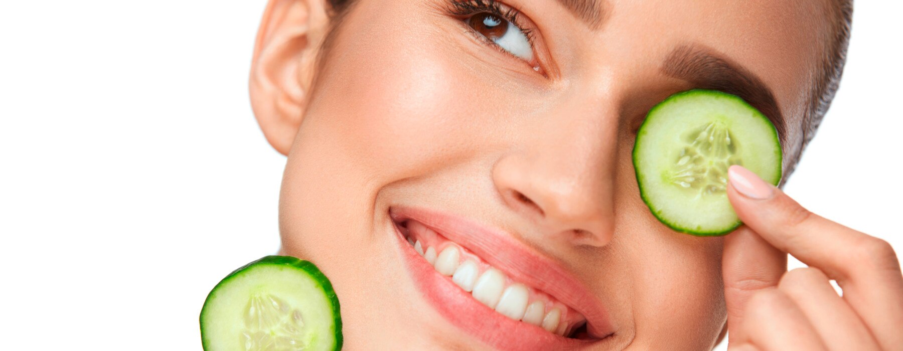 beautiful woman with healthy skin holding slices of cucumber